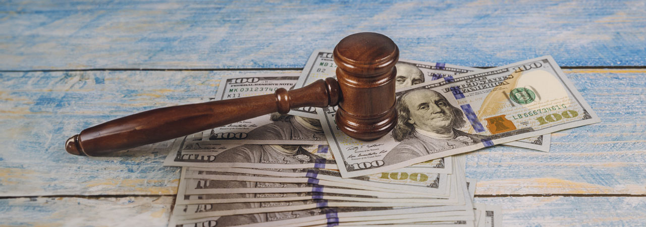 judge gavel and money on blue wooden table