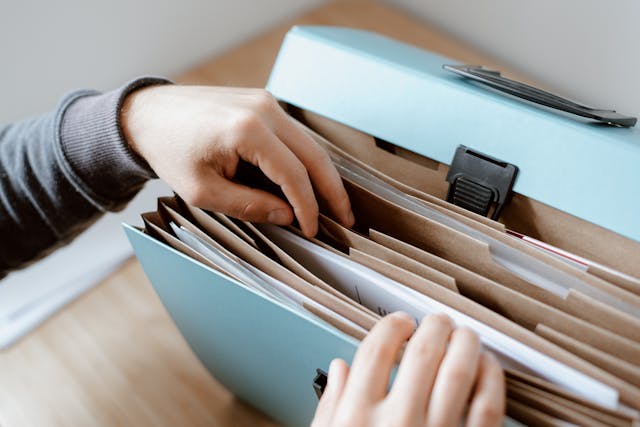 person looking through document file