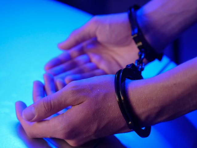 man with hands in handcuffs