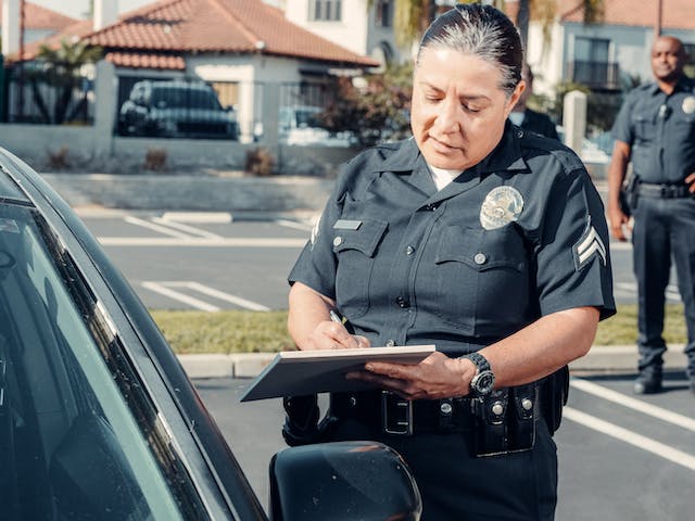 officer standing outside of car window